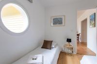 a room with a white couch and a round window at Villa des Sables in Lège-Cap-Ferret