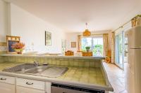 a kitchen with a sink and a refrigerator at Villa des Sables in Lège-Cap-Ferret