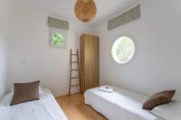 a bedroom with two beds and a window at Villa des Sables in Lège-Cap-Ferret