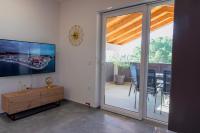 Televízia a/alebo spoločenská miestnosť v ubytovaní Apartmani Lavanda