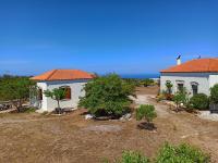 a white house with an orange roof at Kastraki Art Houses in Kousounárion