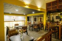 a dining room with tables and chairs in a restaurant at Tuong Boutique Resort Mui ne in Mui Ne