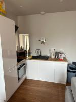 a kitchen with white cabinets and a stove top oven at *Le Terracotta* T2 Hyper-Centre in Roanne