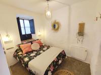 A bed or beds in a room at La Martela de Fuentes Casa de diseño rural