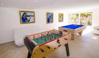 a living room with a foos ball and a table at Grande Villa à Sainte Maxime - Golfe de Saint Tropez in Sainte-Maxime