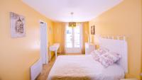 a bedroom with a white bed and a desk at Grande Villa à Sainte Maxime - Golfe de Saint Tropez in Sainte-Maxime