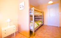 a bedroom with a bunk bed and a dresser and a door at Grande Villa à Sainte Maxime - Golfe de Saint Tropez in Sainte-Maxime