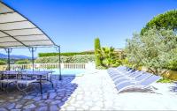 a patio with chairs and a table and a pool at Grande Villa à Sainte Maxime - Golfe de Saint Tropez in Sainte-Maxime