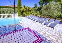 a group of chairs sitting next to a swimming pool at Grande Villa à Sainte Maxime - Golfe de Saint Tropez in Sainte-Maxime