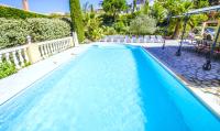 a swimming pool with blue water in a house at Grande Villa à Sainte Maxime - Golfe de Saint Tropez in Sainte-Maxime