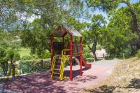 a playground with a slide in a park at Grande Villa à Sainte Maxime - Golfe de Saint Tropez in Sainte-Maxime