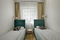 Łóżko lub łóżka w pokoju w obiekcie Apartamenty MM - Rzeźniczaka