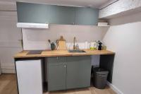 a kitchen with a counter top and a sink at Dans les nuages - T2 Spacieux Standing - Metro - Wifi in Toulouse