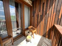 a room with a balcony with a wooden wall at Vlasinsko jezero VILA BEST in Surdulica