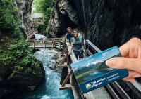 two people standing on a bridge over a river at Bergdorf Hotel Zaglgut in Kaprun