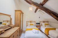 a attic bedroom with two beds and a mirror at ROCHE-LOIRE in Le Thoureil
