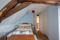 a bedroom with a bed and a wooden ceiling at ROCHE-LOIRE in Le Thoureil