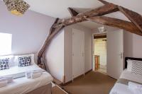 a bedroom with two beds in a attic at ROCHE-LOIRE in Le Thoureil