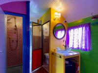 a colorful bathroom with a sink and a shower at Azienda agricola Della Mezzaluna in Stiava