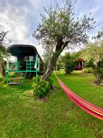 a hammock is tied to a tree in a yard at Azienda agricola Della Mezzaluna in Stiava
