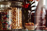 a group of glass jars filled with different types of peanuts at Maison Saintonge in Paris