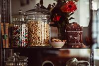 a shelf with glass jars filled with nuts and candy at Maison Saintonge in Paris