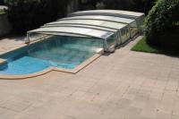 a swimming pool with a roof on a patio at Cadre d&#39;exception in Orange