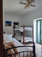 a bedroom with two bunk beds and a ceiling fan at KATKA Karavas in Kythira