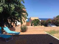 a couple of blue chairs sitting in a yard at Jolie T2 bord de mer corse du sud in Conca