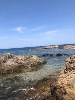 a view of the ocean with rocks in the water at Jolie T2 bord de mer corse du sud in Conca