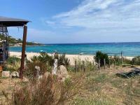 a view of a beach with the ocean in the background at Jolie T2 bord de mer corse du sud in Conca