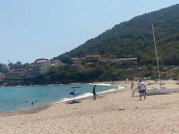 a group of people on a beach with a boat at Jolie T2 bord de mer corse du sud in Conca