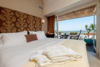 a bedroom with a white bed with a view of the ocean at Hotel Boutique V in Vejer de la Frontera