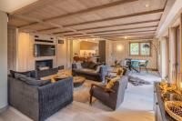 a living room with couches and a table at Bleu Eskape - Appartement in Megève