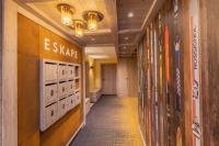 a hallway in a building with an exit valve sign on the wall at Bleu Eskape - Appartement in Megève