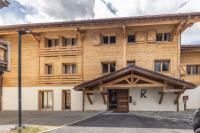 a large wooden building with the k on it at Bleu Eskape - Appartement in Megève