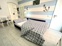 Łóżko lub łóżka w pokoju w obiekcie Cà del Mar - La Spezia e Cinque Terre