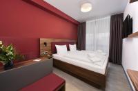 a bedroom with a bed and a red wall at Hotel Rhönkitz in Bad Kissingen