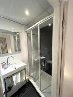 a bathroom with a glass shower and a sink at Residence OLit Cathédrale in Strasbourg