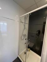a bathroom with a shower with a glass door at Residence OLit Cathédrale in Strasbourg