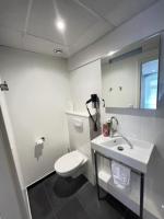 a white bathroom with a toilet and a sink at Residence OLit Cathédrale in Strasbourg