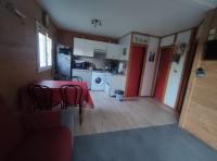 a kitchen and dining room with a table and chairs at Charmant chalet en Auvergne proche du lac in Saint-Rémy-sur-Durolle