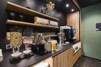 a coffee shop with a counter with many different types at Hotel Rhönkitz in Bad Kissingen