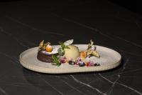 a chocolate dessert on a plate on a table at Hotel Rhönkitz in Bad Kissingen