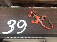 a red lizard sitting on top of a sign at Les margouillats - maisonnette à 2 pas de la plage in Vias