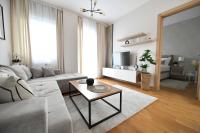 a living room with a couch and a table at Apartman SUN in Inđija