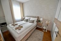 a bedroom with a large bed with two crosses on it at Apartman SUN in Inđija