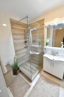 a bathroom with a shower and a sink at Apartman SUN in Inđija