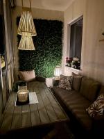 a living room with a couch and a green wall at Apartman SUN in Inđija