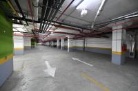 an empty parking lot in a parking garage at Apartman SUN in Inđija